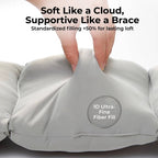Hand pressing into soft lumbar cushion demonstrating plush 1D fiber filling and rebound resilience.